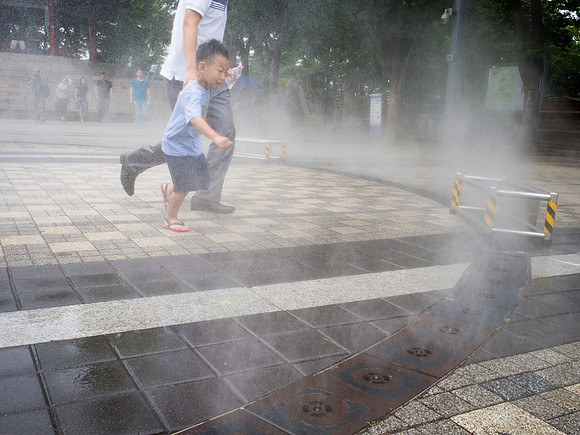 Kid in water mist fountain Near N Seoul Tower